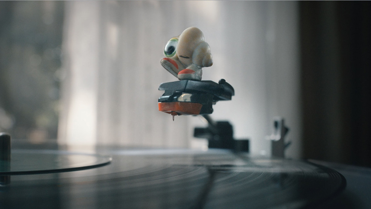 Marcel the shell standing on a record player