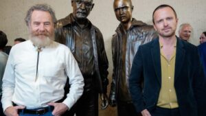 Bryan Cranson and Aaron Paul pose with Breaking Bad statues