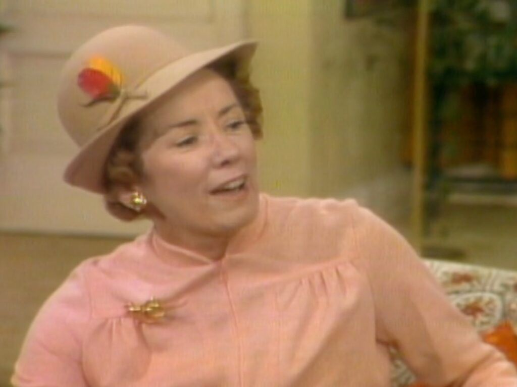 Actress Priscilla Morrill wearing pink blouse and tan hat in "Three's Company"