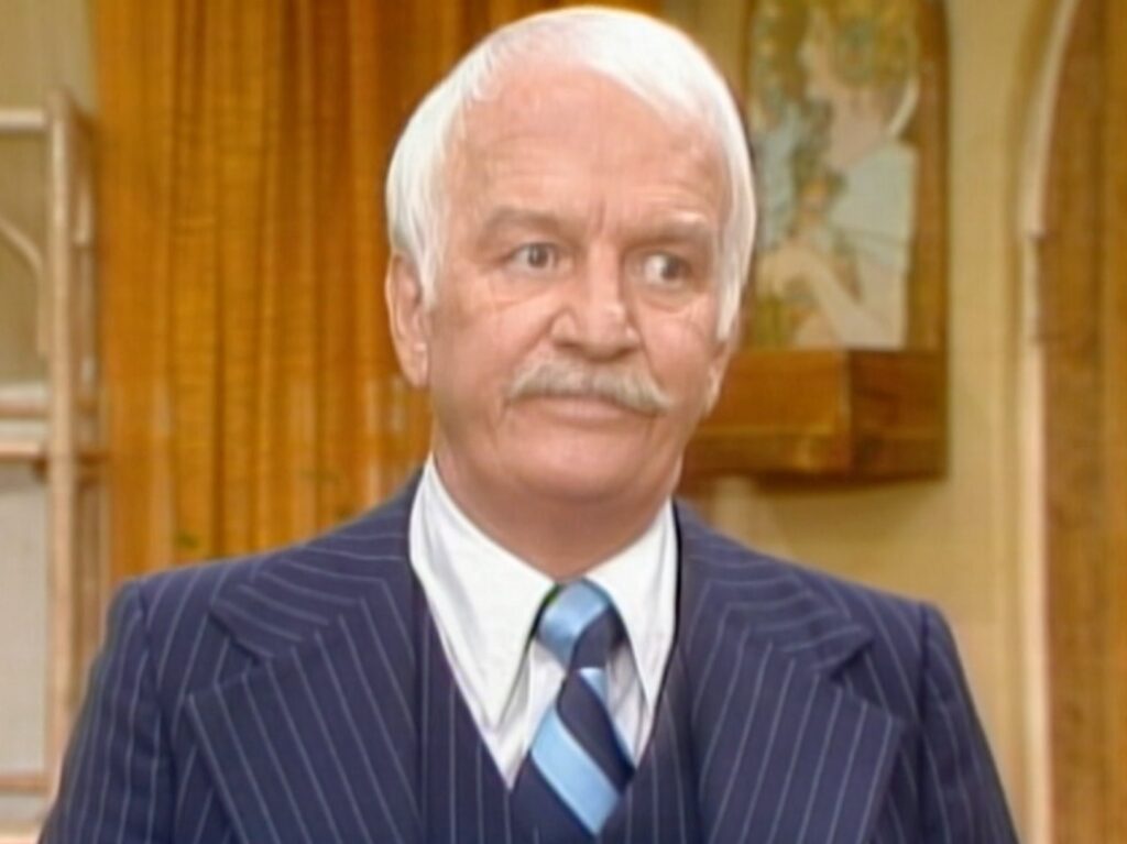 Actor Don Porter appearing in "Three's Company" wearing blue pinstriped suit with striped blue tie
