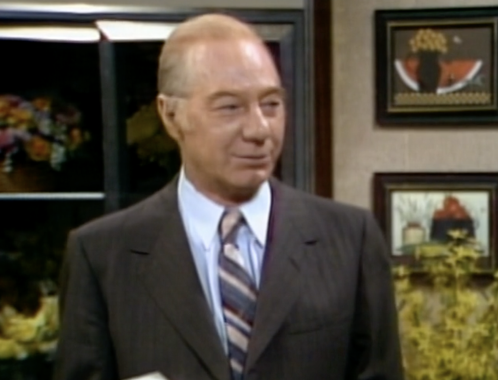 Mickey Deems appearing in "Three's Company," dressed in a suit and tie