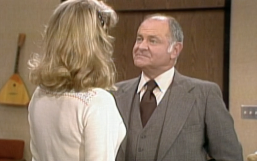 Actor Rod Colbin appearing in "Three's Company," dressed in gray suit and brown tie