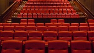 An empty movie theater full of red seats