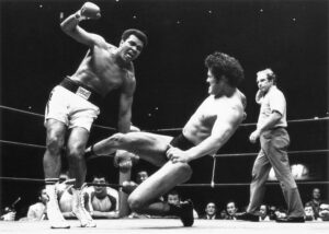 LeBell (right) referees the Muhammad Ali vs. Antonio Inoki fight on June 26, 1976.