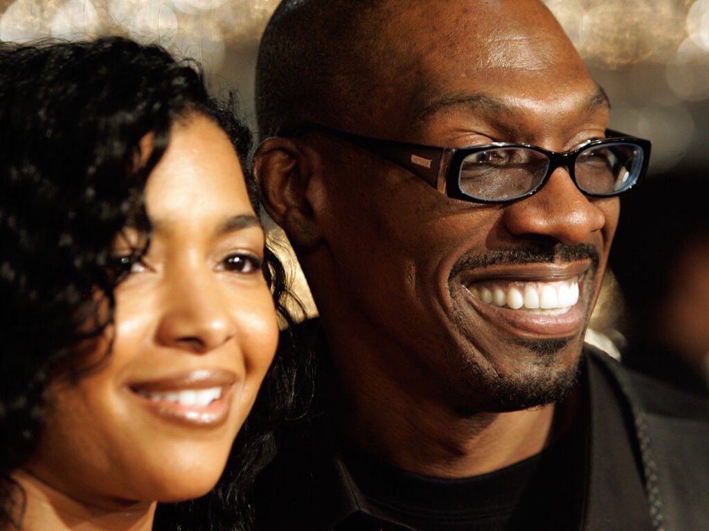 Closeup photo of Charlie Murphy (R) and Tisha Taylor. Both are smiling