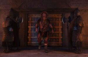 Durin standing in front of a set of double doors with two dwarven guards to the side