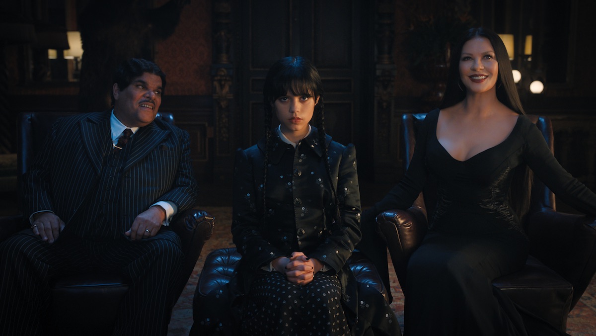 Wednesday sits between her parents Gomex and Morticia Addams
