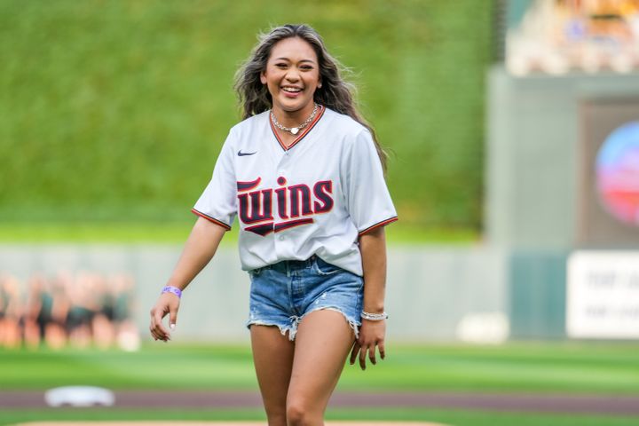 Suni Lee throws out the first pitch at a Minnesota Twins game in August.