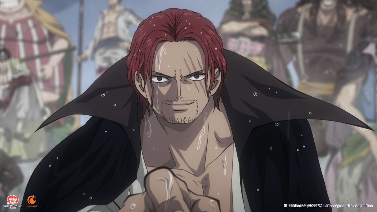 A muscular man with red hair and a cape points at the camera