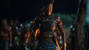 Viola Davis stands with an army in the grassland in the woman king