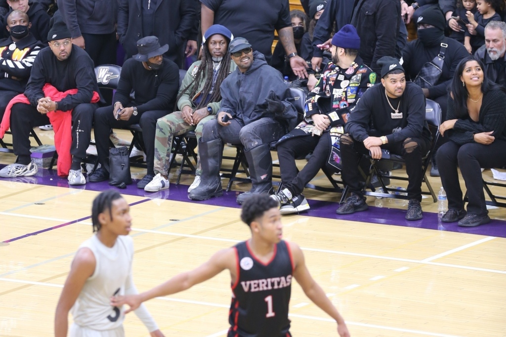 Kanye West watching a Donda Doves basketball game.