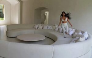 Kim Kardashian runs wild on her white couch inside her white home