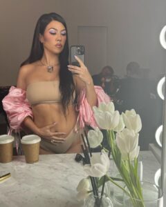Kourtney placed her hand on her stomach in an Instagram photo