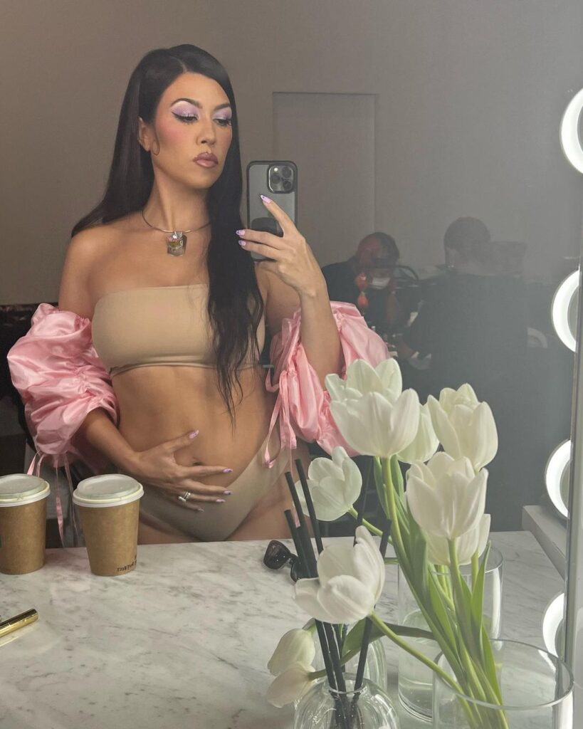 Kourtney placed her hand on her stomach in an Instagram photo