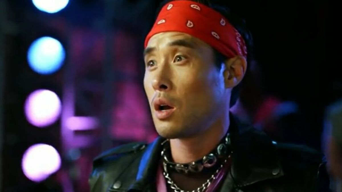 quantum leap star raymond lee wearing a leather jacket and red bandana
