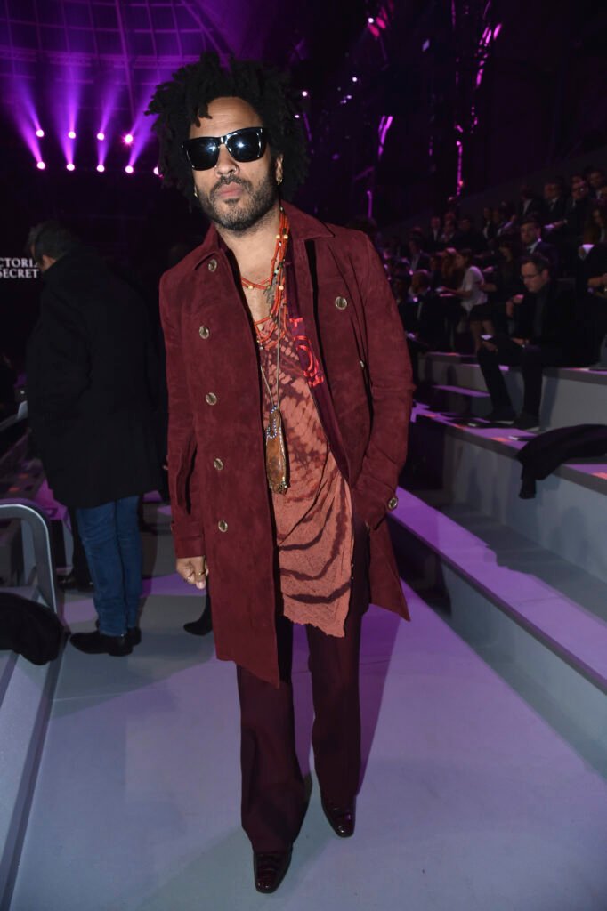 Lenny Kravitz in burgundy suit and black sunglasses