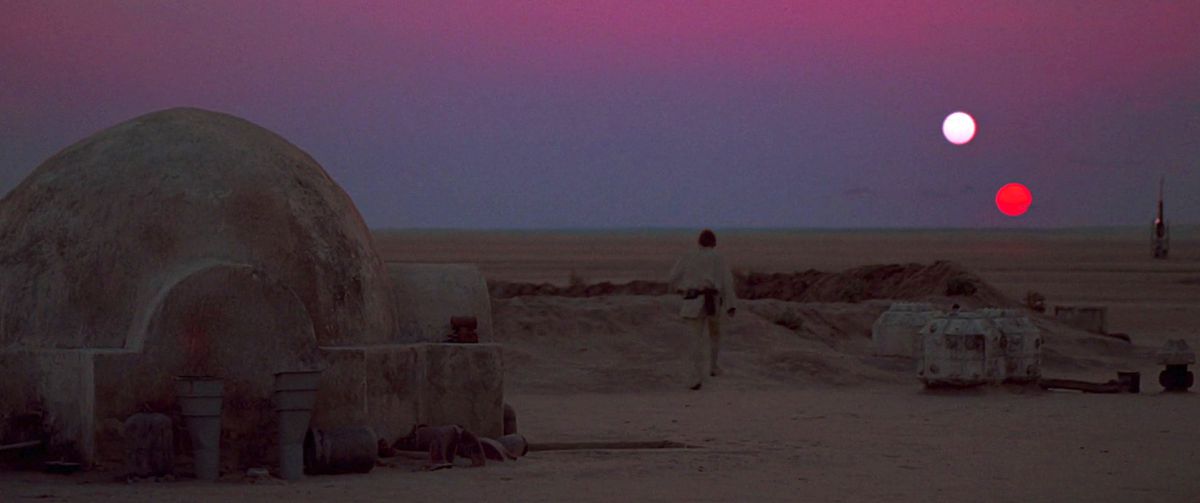 Luke Skywalker walking toward the two-sun sunset on Tatooine in Star Wars: A New Hope