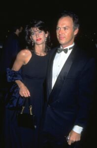 Courteney Cox (L) in dark blue dress with Michael Keaton, who is wearing a black suit and bowtie
