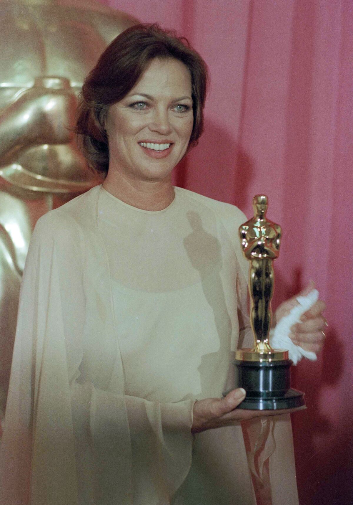 Louise Fletcher holds the Academy Award she won