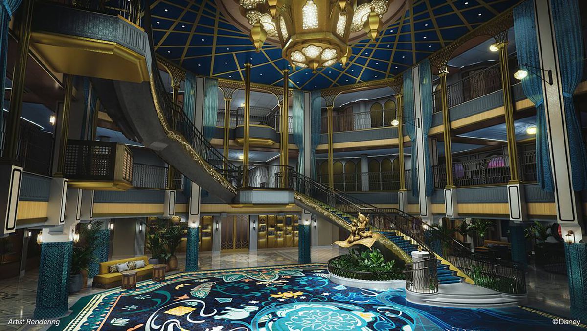 an ornate cruise ship atrium, with a winding staircase, all decorated in blue and gold 