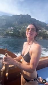 Courteney Cox drives the boat