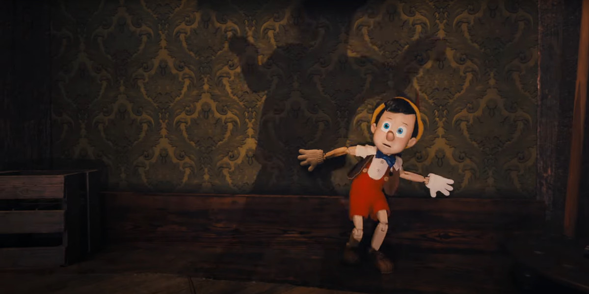 Pinocchio cowering in fear from an unseen threat in Disney Plus’ Pinocchio movie