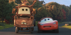 mater and lightning looking at the camera. mater’s rear end is up in the air, because he has “backfired” — aka the car equivalent of farting
