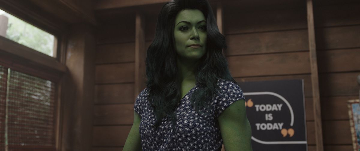 She-Hulk stands in a cabin in front of a motivational poster that says “Today is Today” in the Disney Plus show She-Hulk: Attorney at Law