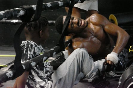 No pain, no gain – a man trains in TG Boxing Gym, South Central LA, as his son looks on