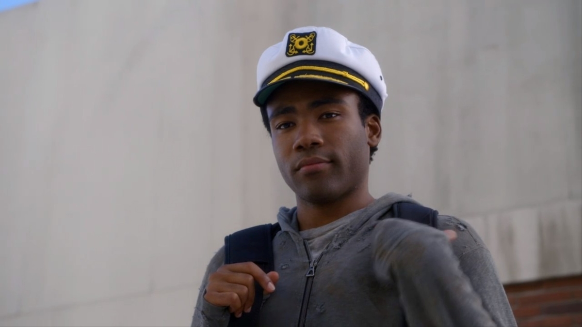 Donald Glover as Troy Barnes wearing a captain's hat in his final episode of Community