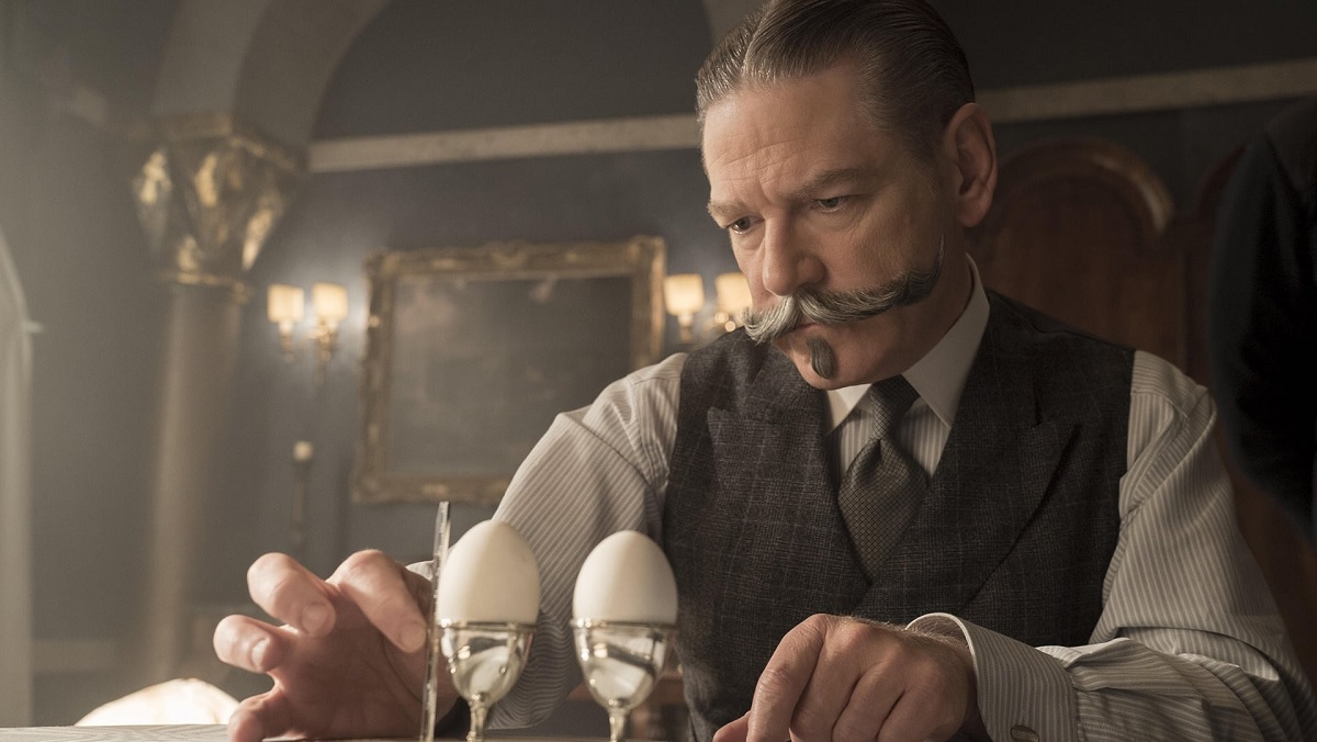 Kenneth Branagh's Hercule Poirot measures the height of eggs in Death on the Nile.