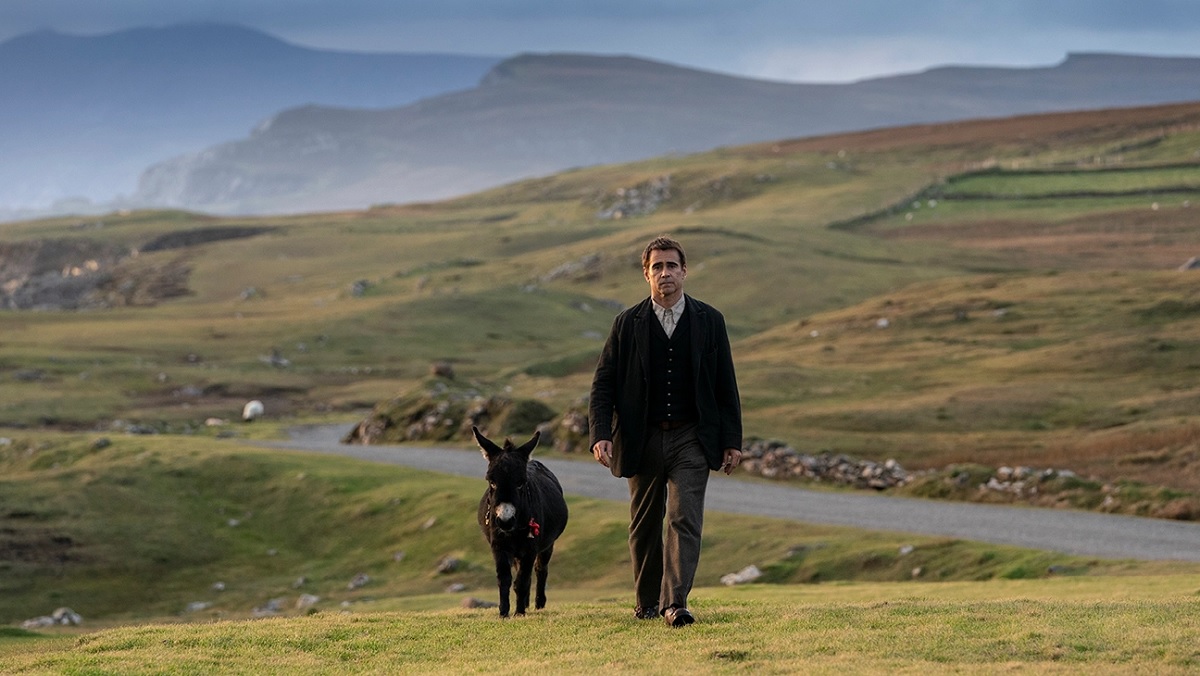 Colin Farrell walks with a donkey against the hilly glens of Ireland in The Banshees of Inisherin.