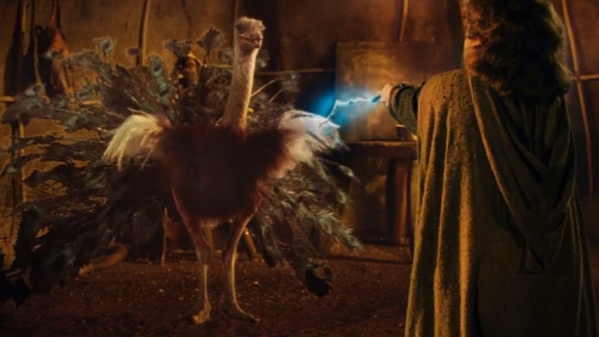 Willow uses a glowing magic wand to transform an ostrich into a peacock in the movie Willow