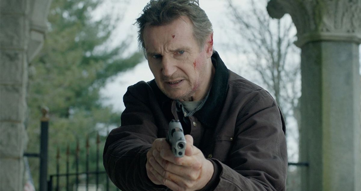 Liam Neeson as Travis Block holding a pistol in Blacklight.
