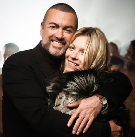 George Michael, with close-cropped hair and a beard, hugs Kate Moss, wearing a fur-lined hood