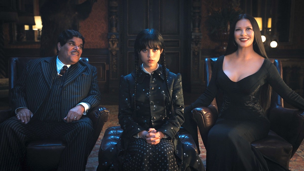 Wednesday sits between her parents Gomex and Morticia Addams