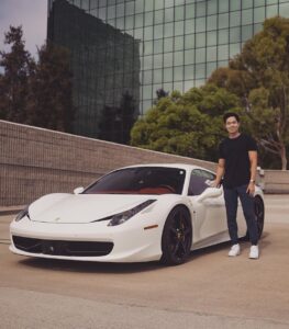 Charlie Chang posing with his brand new Ferrari