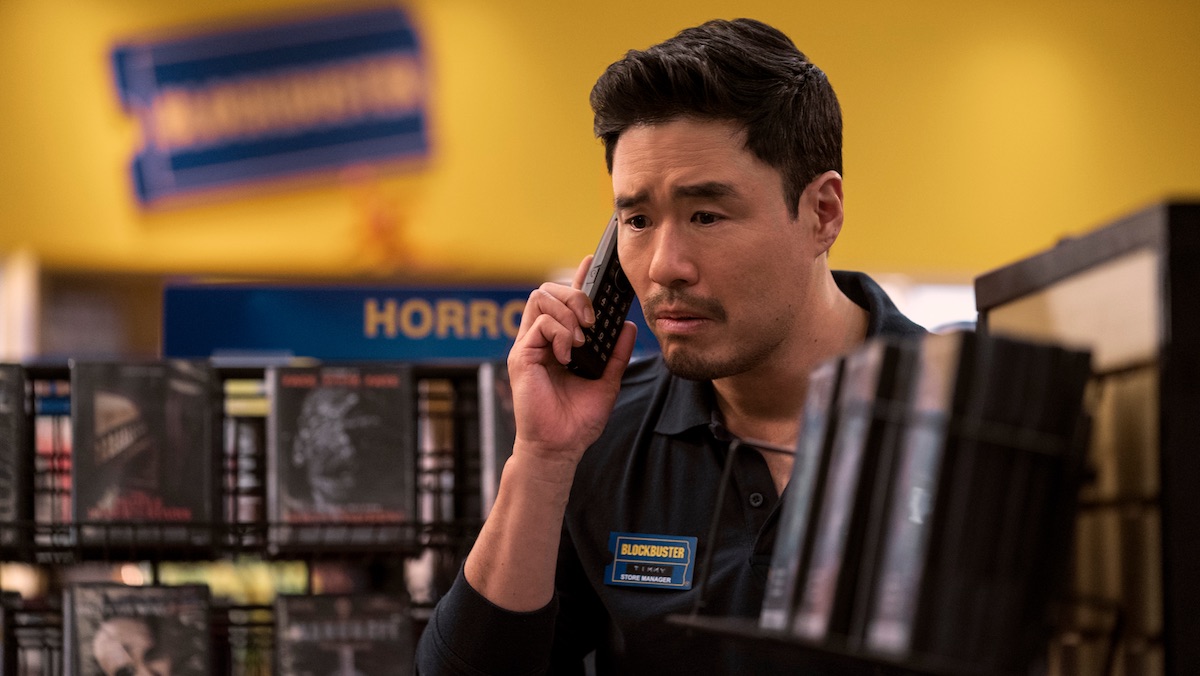 Randall Park on the phone while working on Netflix's Blockbuster for trailer article.