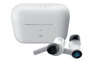 The white PlayStation version of the Hammerhead HyperSpeed headphones by Razer are shown sitting outside of their charging case.