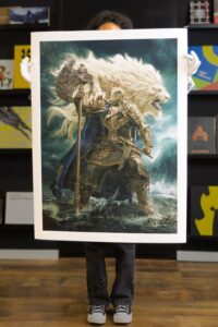 A photo of an art print featuring Godfrey from the video game Elden Ring.