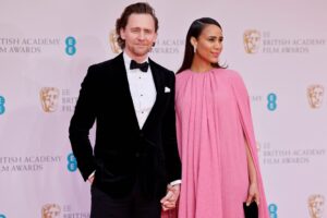British actor Tom Hiddleston (L) and British actress Zawe Ashton pose on the red carpet upon arrival at the BAFTA British Academy Film Awards at the Royal Albert Hall, in London, on March 13, 2022. (Photo by Tolga Akmen / AFP) (Photo by TOLGA AKMEN/AFP via Getty Images)