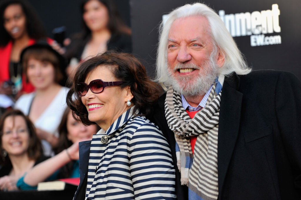 Donald Sutherland (R) and his wife Francine Racette in matching black and white striped outfits