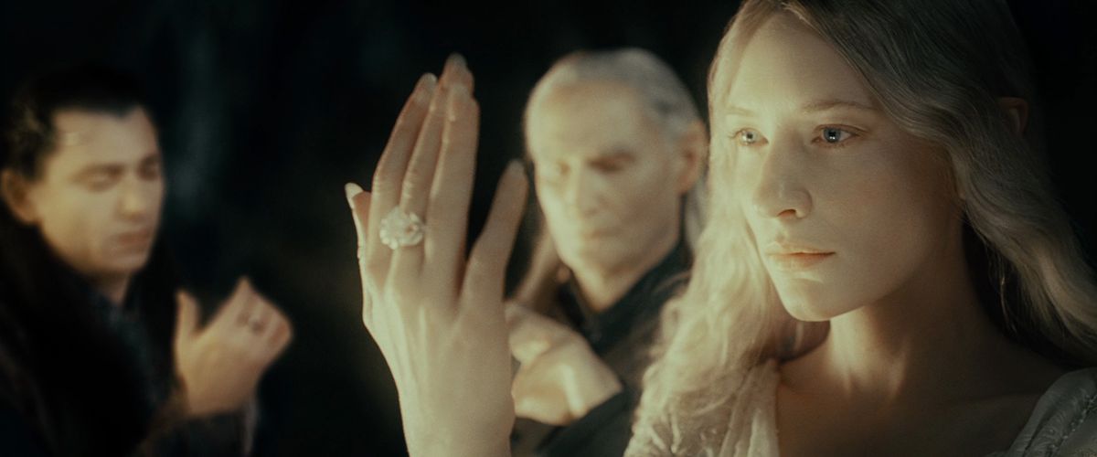 Galadriel displays her elven ring, worn on the middle finger of her white hand, in The Fellowship of the Ring.