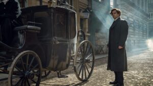 Sherlock Holmes stands in front of carriage in Enola Holmes 2