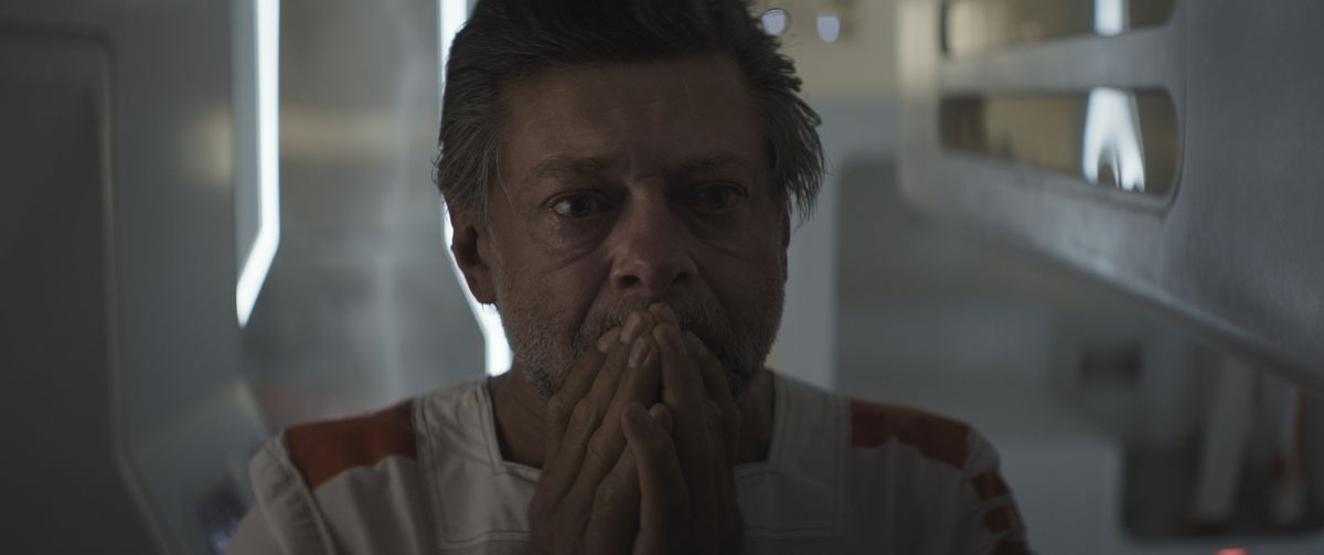 Andy Serkis holds his hands to his face in shock in Andor.