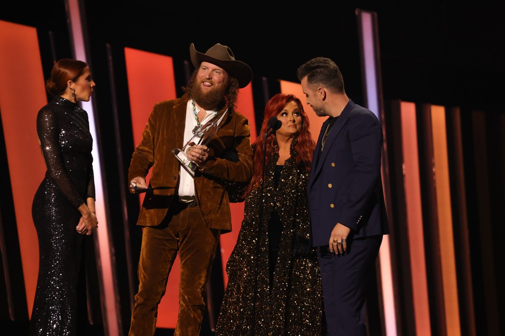 John Osborne, Wynona Judd, and T.J. Osborne speak onstage at the 56th Annual CMA Awards