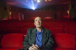 A man sitting alone in a movie theater in the documentary "Only in Theaters."