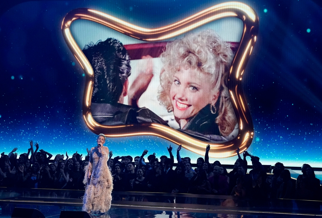Pink performing in front of an Olivia Newton-John "Grease" still at the AMAs.