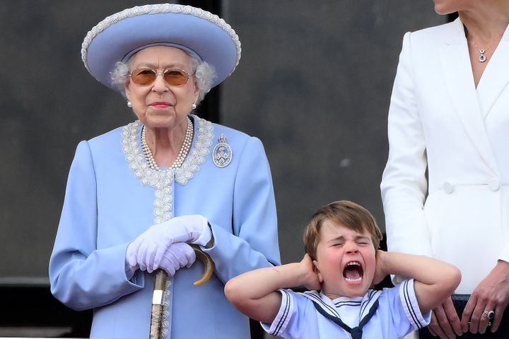 Prince Louis holds his ears as he stands next to Queen Elizabeth II to watch a special flypast from Buckingham Palace balcony following Trooping the Colour on June 2. 