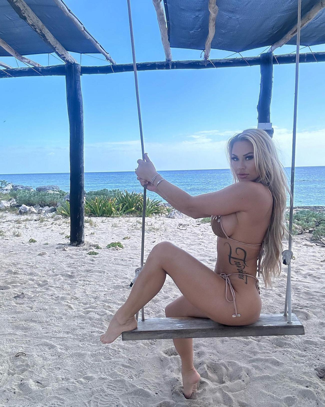 Kindly Myers on a swing in a bikini